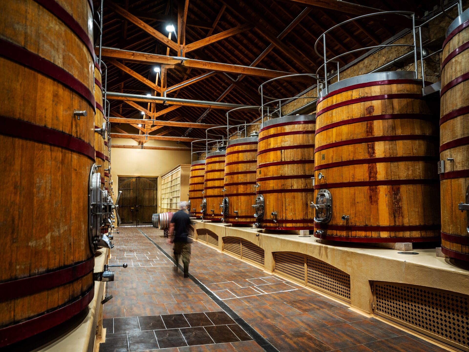 Guests walking through the barrel hall at Ode Winery.