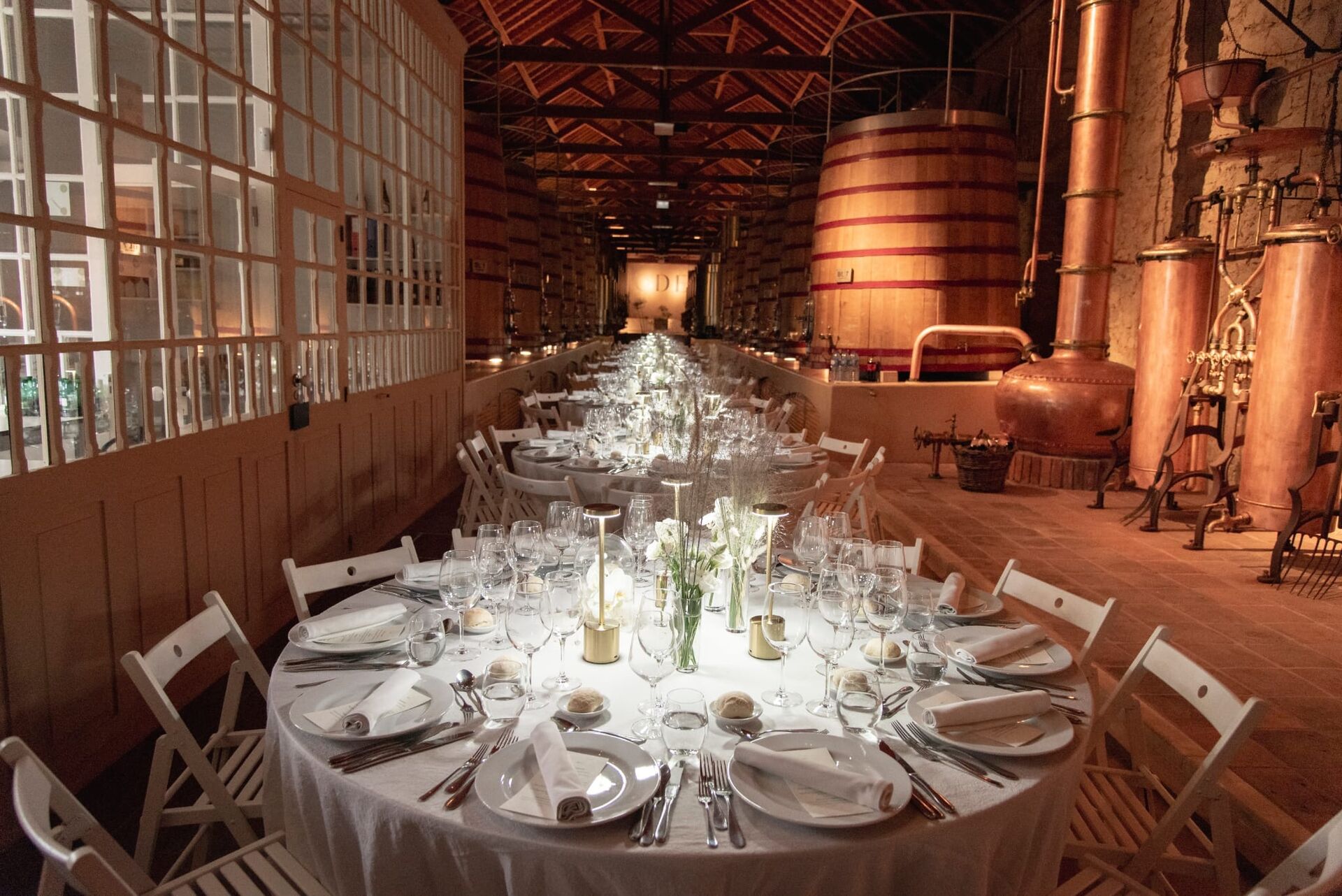 A private dinner set at a round table in the Ode cellar.