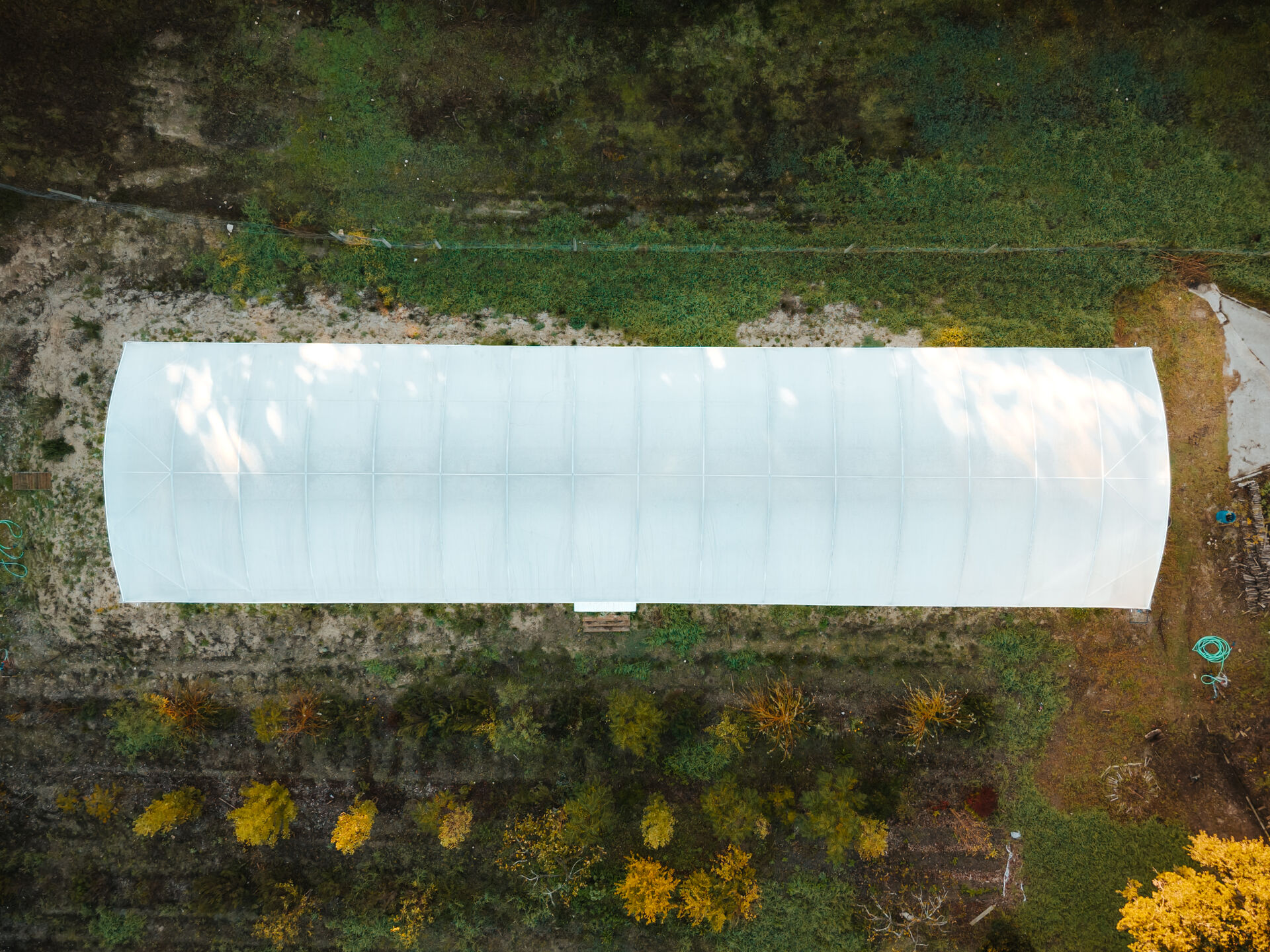 Aerial view of Ode Farm and its greenhouse.