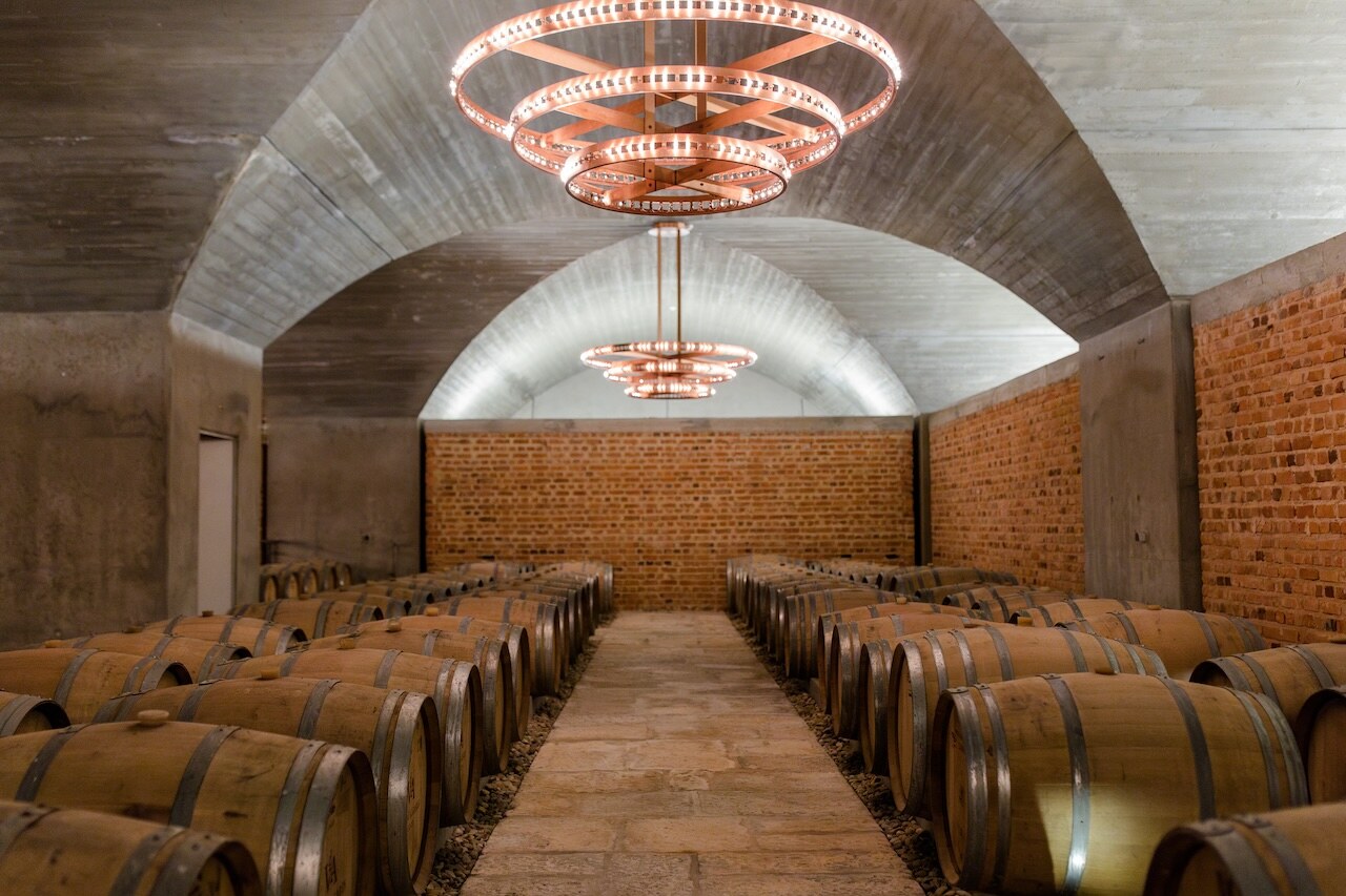 The vaulted brick cellar with copper chandeliers at ODE Winery.